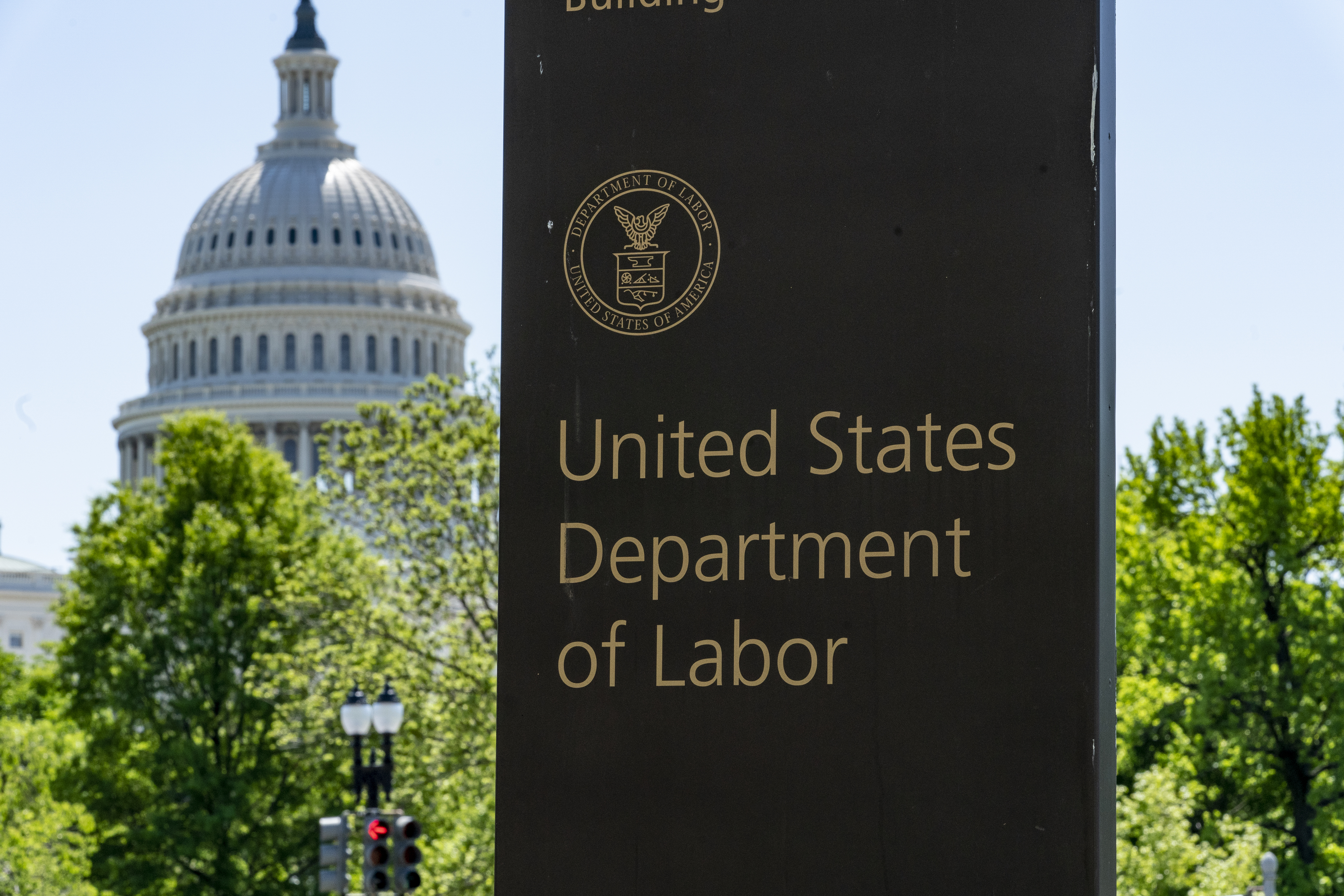 In this May 7, 2020, file photo, the entrance to the Labor Department is seen near the Capitol in Washington. Unemployment fraud in the U.S. has reached dramatic levels during the pandemic: more than $63 billion has been paid out improperly through fraud or errors since March 2020. Criminals are seizing on the opportunity created by the pandemic and are making false claims using stolen information. (AP Photo/J. Scott Applewhite, File)