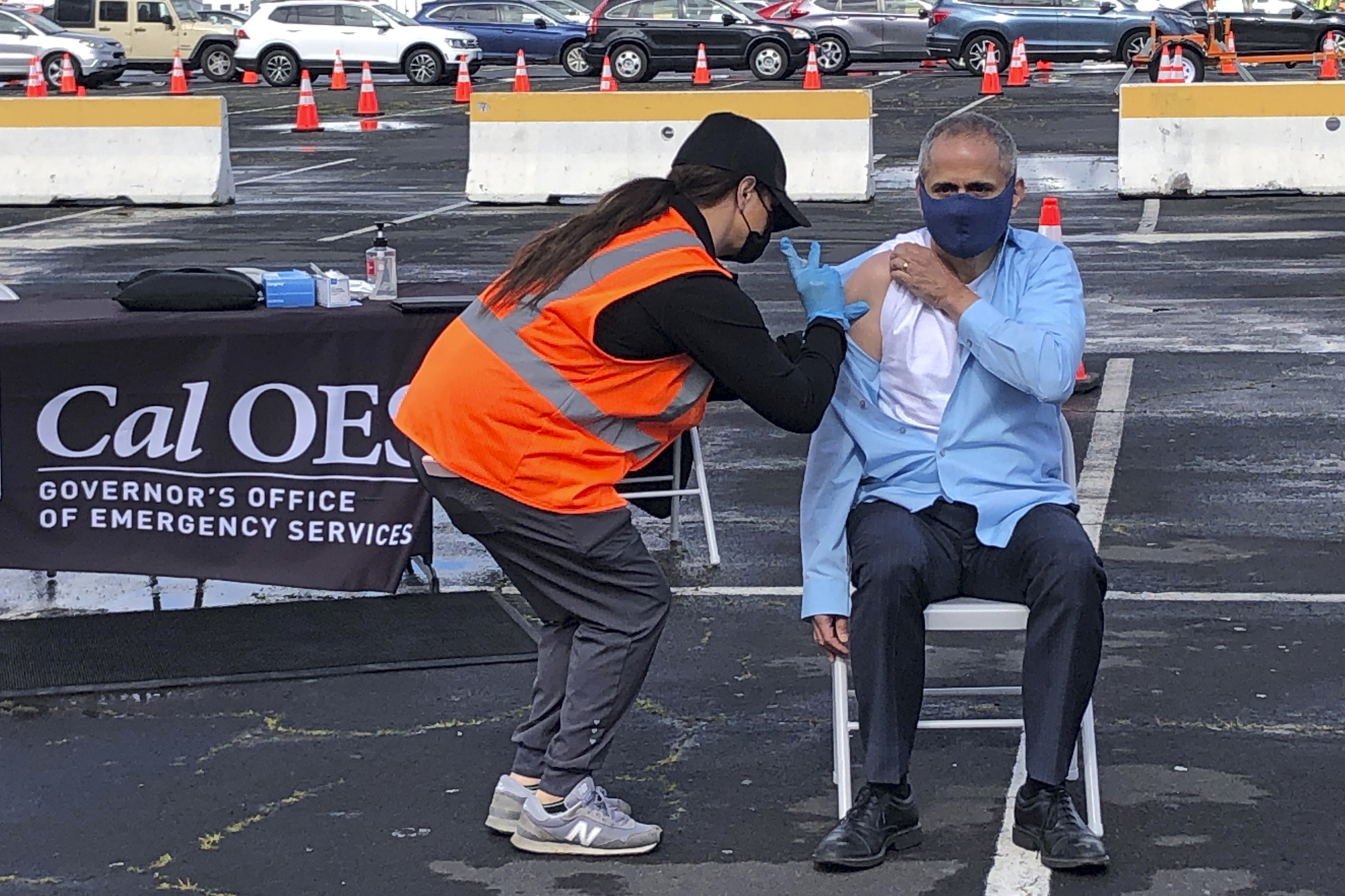 Dr. Tomas Aragon, State Public Health Officer and California Department of Public Health Director, takes part in a vaccination event at the RingCentral Coliseum in Oakland, Calif., on Thursday, March 11, 2021, to highlight the new one-dose Janssen COVID-19 vaccine by Johnson & Johnson. (AP Photo/Haven Daley)