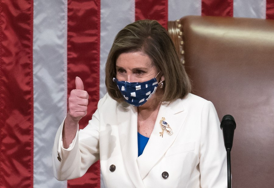 Speaker of the House Nancy Pelosi, D-Calif., gestures after the $1.9 trillion COVID-19 relief bill was passed at the Capitol in Washington on March 10, 2021. (J. Scott Applewhite / Associated Press)