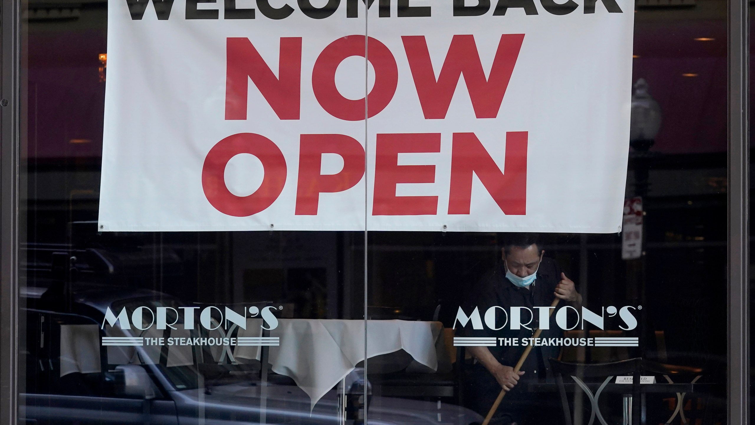 In this March 4, 2021, file photo, a sign reading "Welcome Back Now Open" is posted on the window of a Morton's Steakhouse restaurant as a man works inside during the coronavirus pandemic in San Francisco. (AP Photo/Jeff Chiu, File)In this March 4, 2021, file photo, a sign reading "Welcome Back Now Open" is posted on the window of a Morton's Steakhouse restaurant as a man works inside during the coronavirus pandemic in San Francisco. (AP Photo/Jeff Chiu, File)