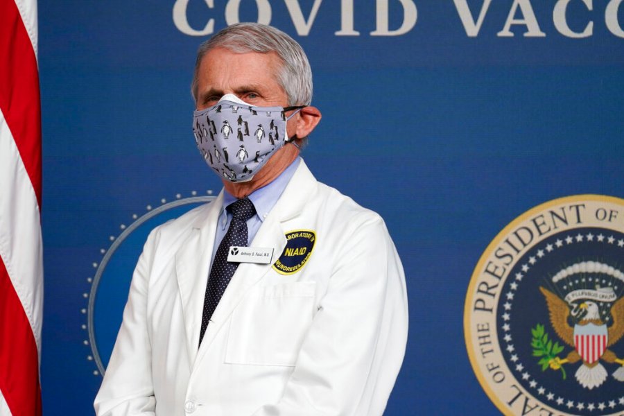 In this Feb. 25, 2021, Dr. Anthony Fauci, director of the National Institute of Allergy and Infectious Diseases, listens as President Joe Biden speaks during an event to commemorate the 50 millionth COVID-19 shot in Washington. Fauci said Sunday, March 14, he wishes former President Donald Trump would use his popularity among Republicans to persuade his followers to get the COVID-19 vaccine. (AP Photo/Evan Vucci, File)