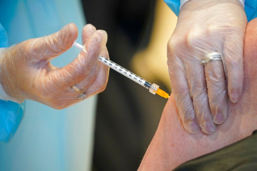 In this Wednesday, March 10, 2021 file photo, a health worker administers a dose of the AstraZeneca vaccine against COVID-19 to a patient inside the convention center known as "La Nuvola", The Cloud, in Rome. (AP Photo/Andrew Medichini, file)