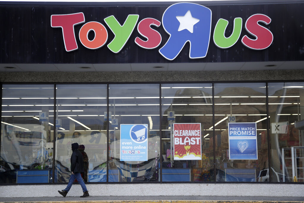 In this Jan. 24, 2018, file photo, a person walks near the entrance to a Toys R Us store, in Wayne, N.J. (AP Photo/Julio Cortez, File)