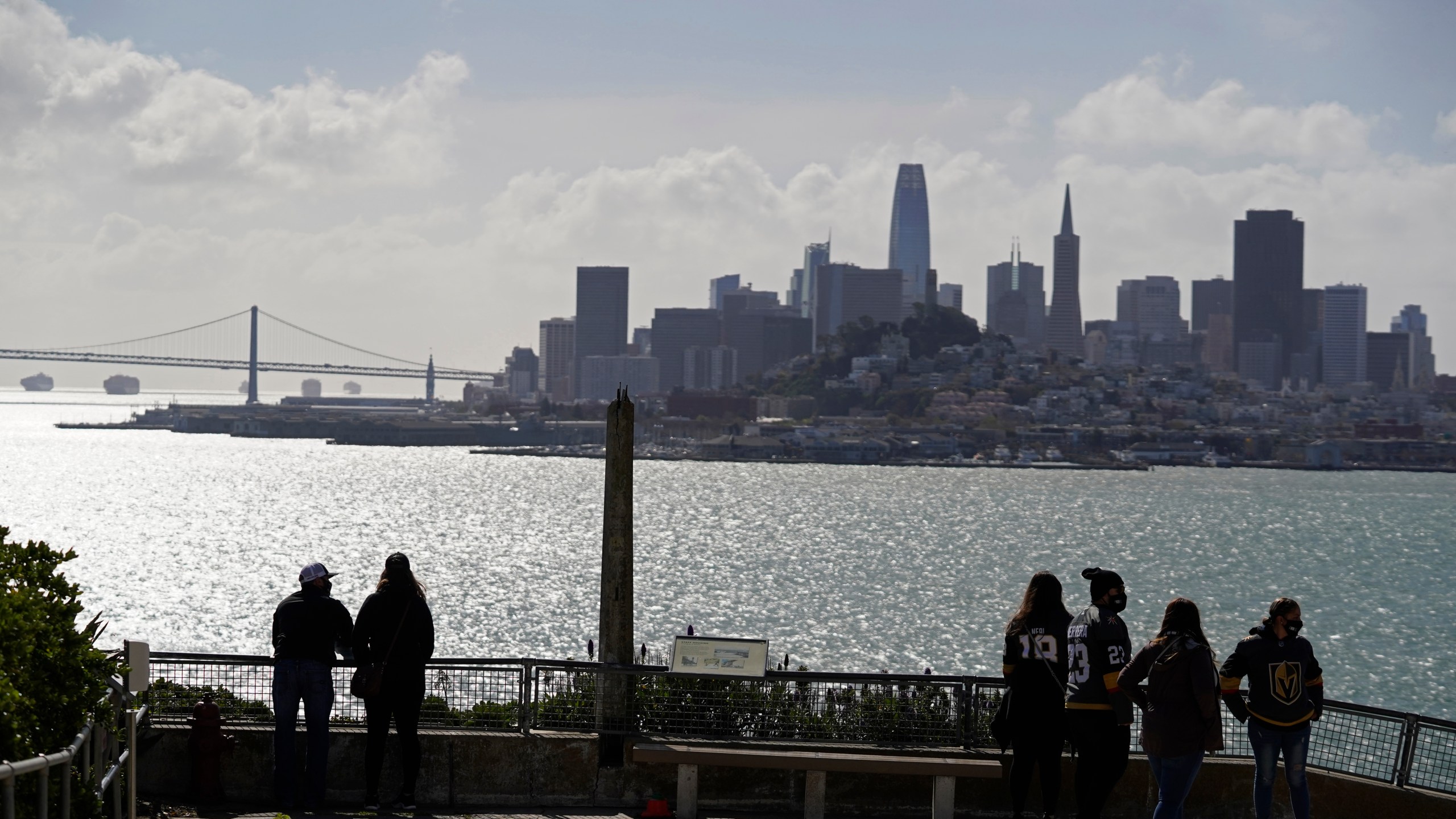 People look out at the views of the skyline and bay from Alcatraz Island in San Francisco, Monday, March 15, 2021. (AP Photo/Eric Risberg)