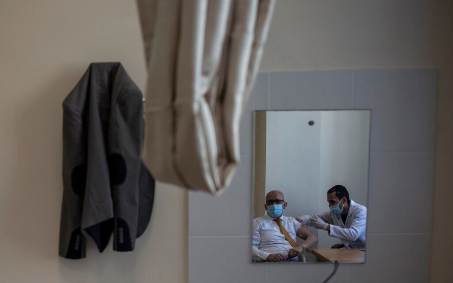 A Palestinian man receives a shot of the Russian-made Sputnik V coronavirus vaccine, at an UNRWA clinic in Gaza City, Wednesday, March 17, 2021. (AP Photo/Khalil Hamra)