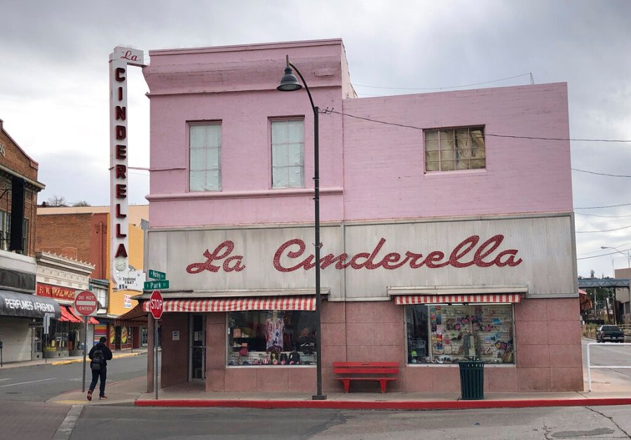 A man walks past a shuttered clothing store in the border town of Nogales, Arizona on March 15, 2021. The store has been in business for nearly half a century but closed because of the pandemic for almost a year, with its main customer base, Mexican day-trippers, largely unable to come to the U.S. and shop. (AP Photo/Suman Naishadham)