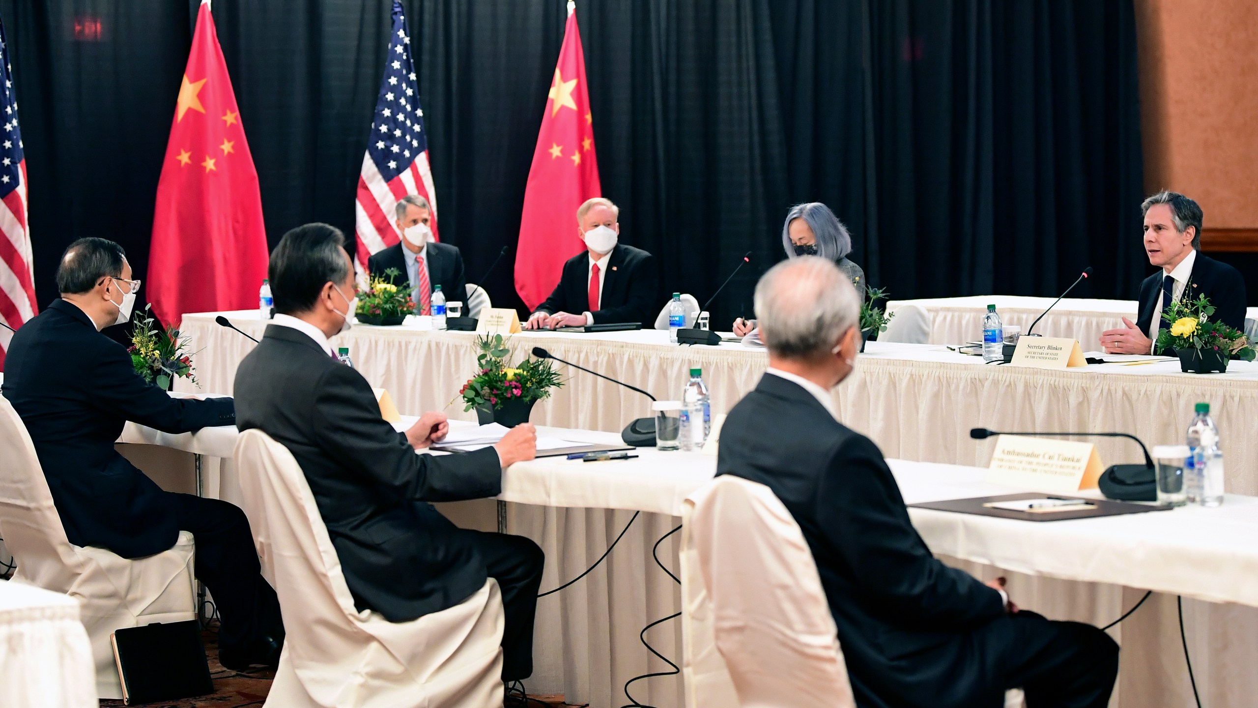 Secretary of State Antony Blinken, speaks as Chinese Communist Party foreign affairs chief Yang Jiechi, left, and China's State Councilor Wang Yi, second from left, listen at the opening session of US-China talks at the Captain Cook Hotel in Anchorage, Alaska, Thursday, March 18, 2021. (Frederic J. Brown/Pool via AP)