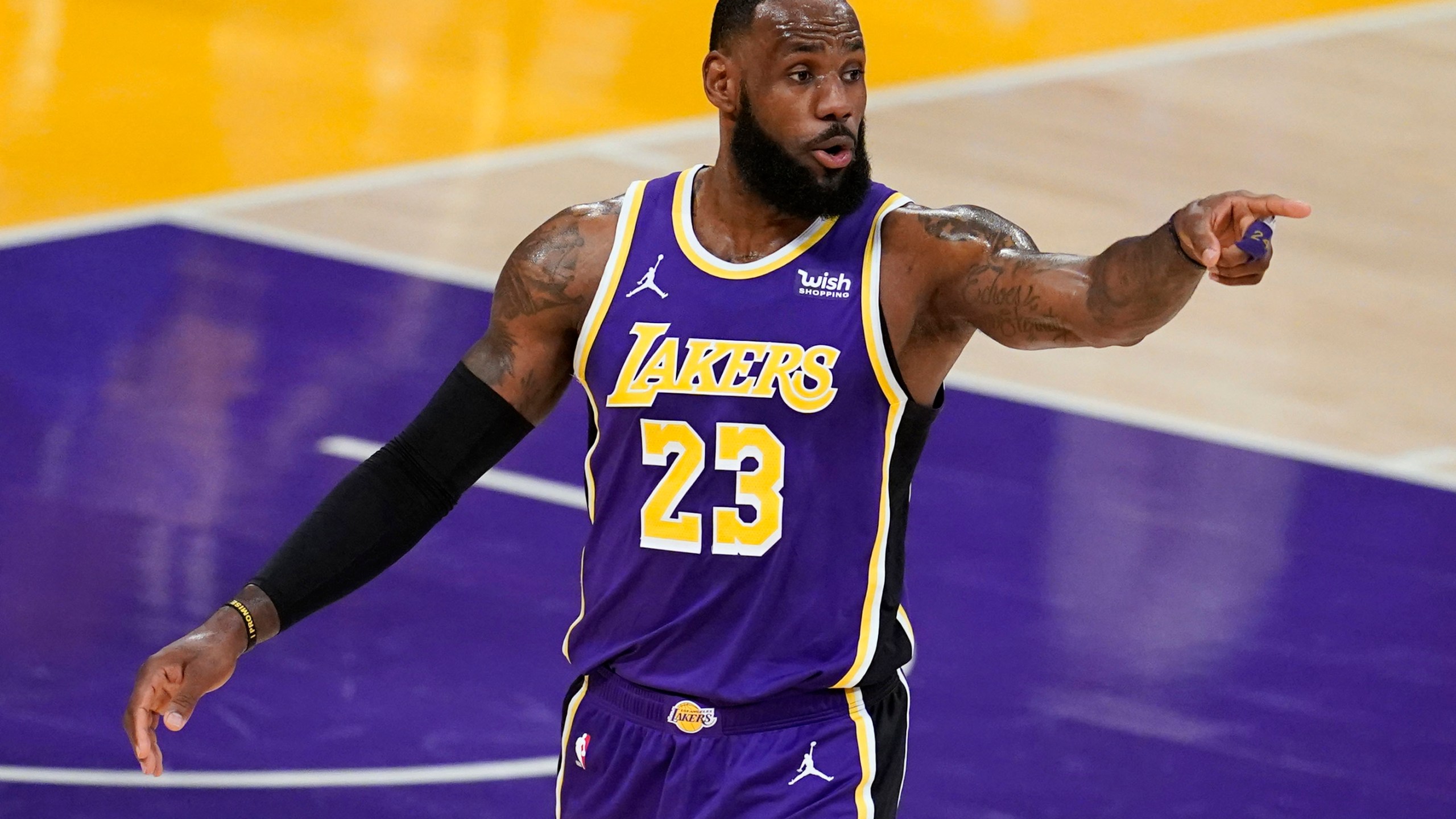 Los Angeles Lakers forward LeBron James signals to a teammate during the first half of an NBA basketball game against the Charlotte Hornets on Thursday, March 18, 2021, in Los Angeles. (AP Photo/Marcio Jose Sanchez)