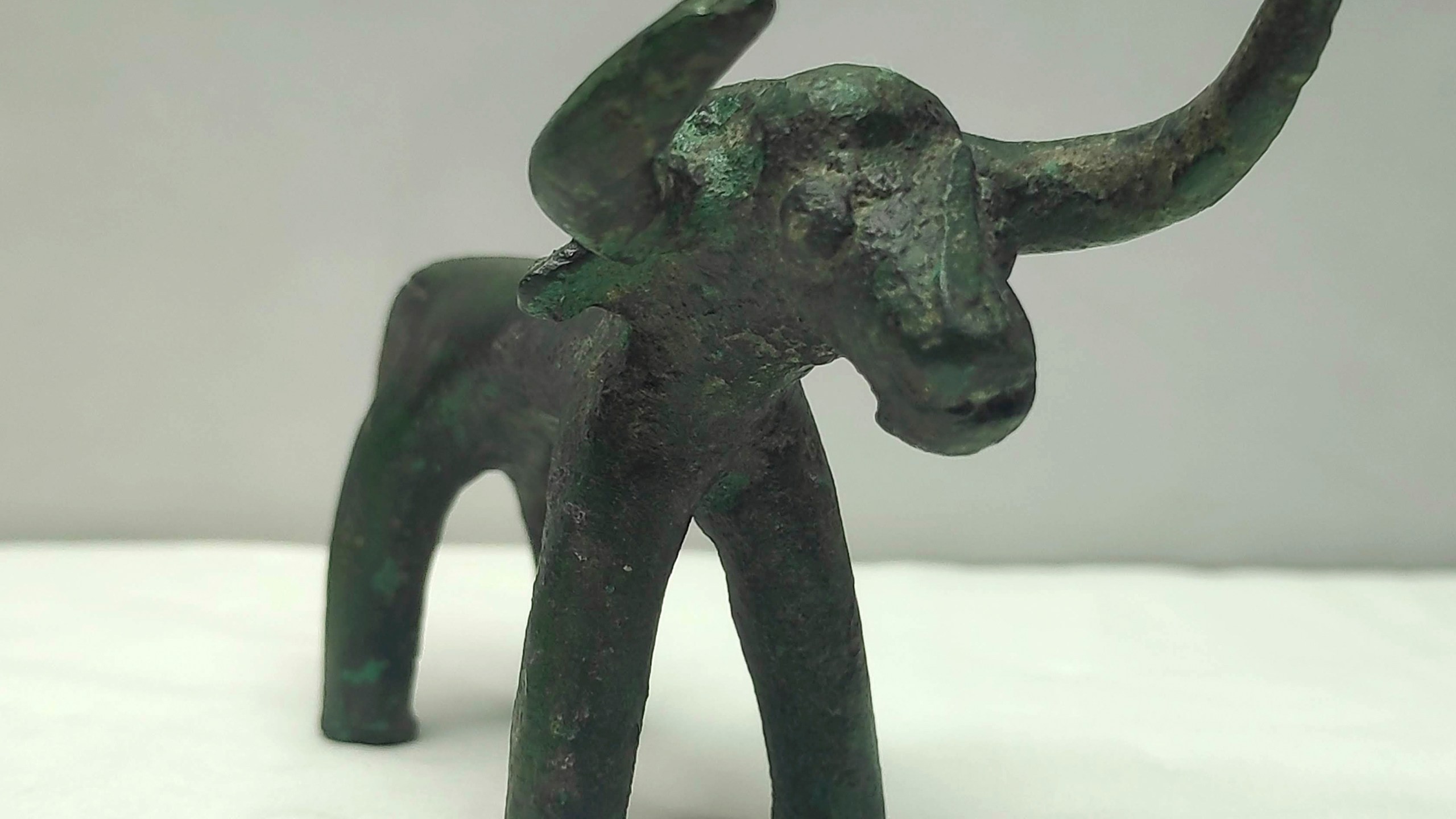 This undated photo provided by the Greek Culture Ministry on Friday, March 19, 2021 shows an ancient bronze bull figurine that was found in ancient Olympia . Heavy recent rainfall in southern Greece has led to the discovery of a bronze bull figurine believed to have been a votive offering made to the god Zeus in Ancient Olympia as early as 3,000 years ago.(Greek Culture Ministry via AP)