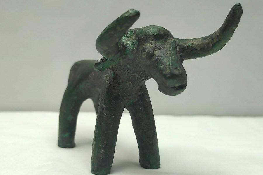 This undated photo provided by the Greek Culture Ministry on Friday, March 19, 2021 shows an ancient bronze bull figurine that was found in ancient Olympia . Heavy recent rainfall in southern Greece has led to the discovery of a bronze bull figurine believed to have been a votive offering made to the god Zeus in Ancient Olympia as early as 3,000 years ago.(Greek Culture Ministry via AP)