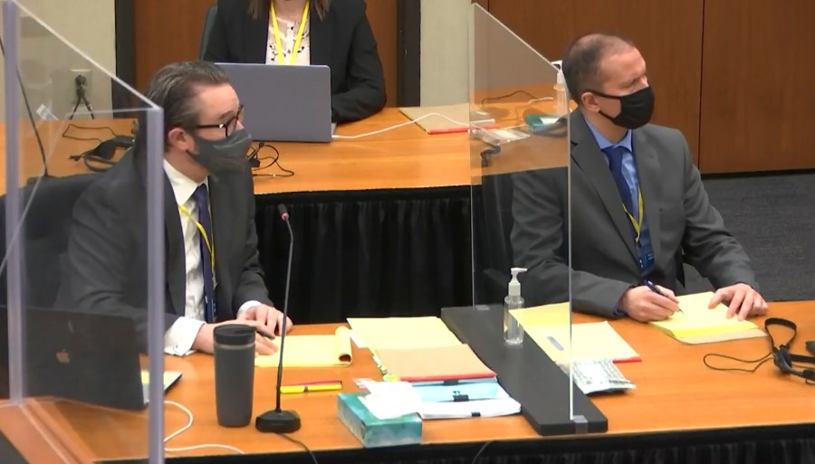 In this screen grab from video, defense attorney Eric Nelson, left, and defendant and former Minneapolis police officer Derek Chauvin, right, listen as Hennepin County Judge Peter Cahill discusses pre-trial motions, prior to continuing jury selection, Friday, March 19, 2021, at the Hennepin County Courthouse in Minneapolis, Minn. (Court TV via AP, Pool)