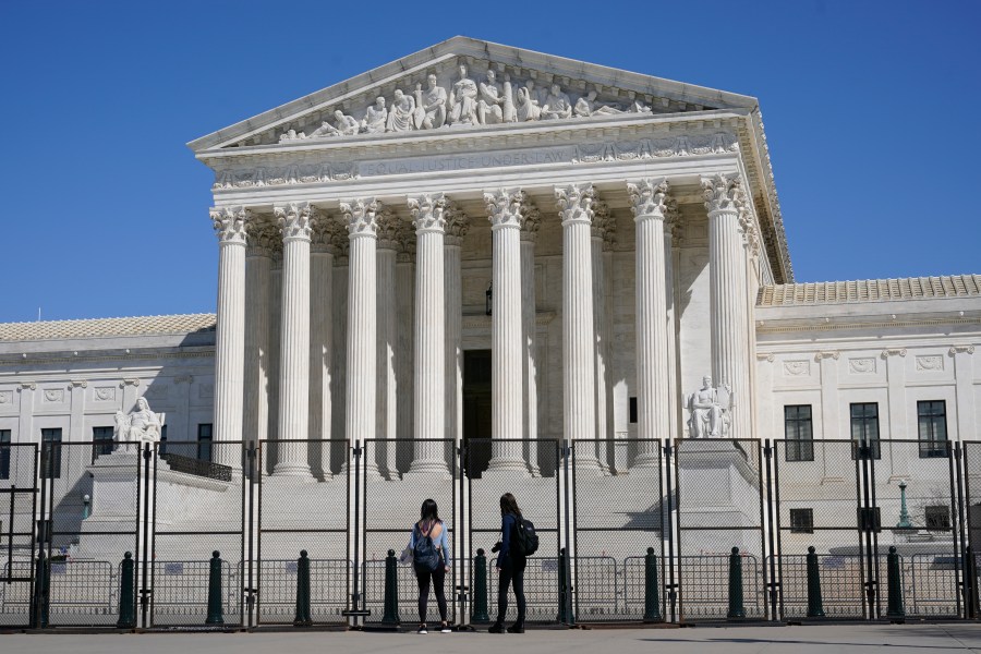 People view the Supreme Court building from behind security fencing on March 21, 2021. (Patrick Semansky/Associated Press)