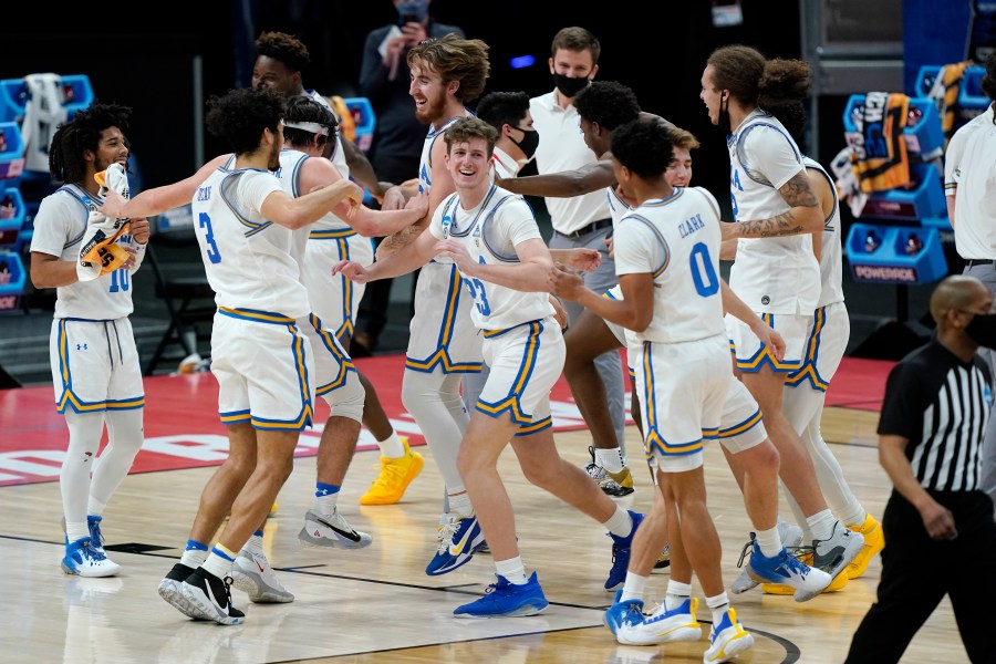 UCLA players celebrate their win over Abilene Christian in a college basketball game in the second round of the NCAA tournament at Bankers Life Fieldhouse in Indianapolis on March 22, 2021. (Mark Humphrey / Associated Press)