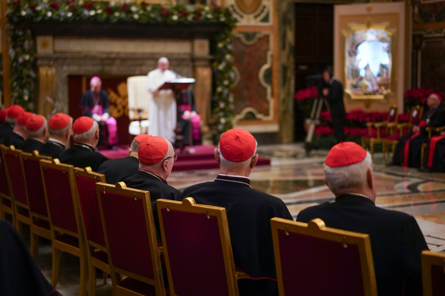 Cardinals listen as Pope Francis, background, delivers his Christmas greetings to the Roman Curia, in the Clementine Hall at the Vatican, Saturday, Dec. 21, 2019. Pope Francis has ordered pay cuts for Holy See employees, including slashing cardinals’ salaries by 10%. Francis in a letter made public by the Vatican on Wednesday, March 24, 2021, noted that the pandemic emergency “negatively impacted all sources of revenue” for the Holy See and Vatican City State. (AP Photo/Andrew Medichini, File)