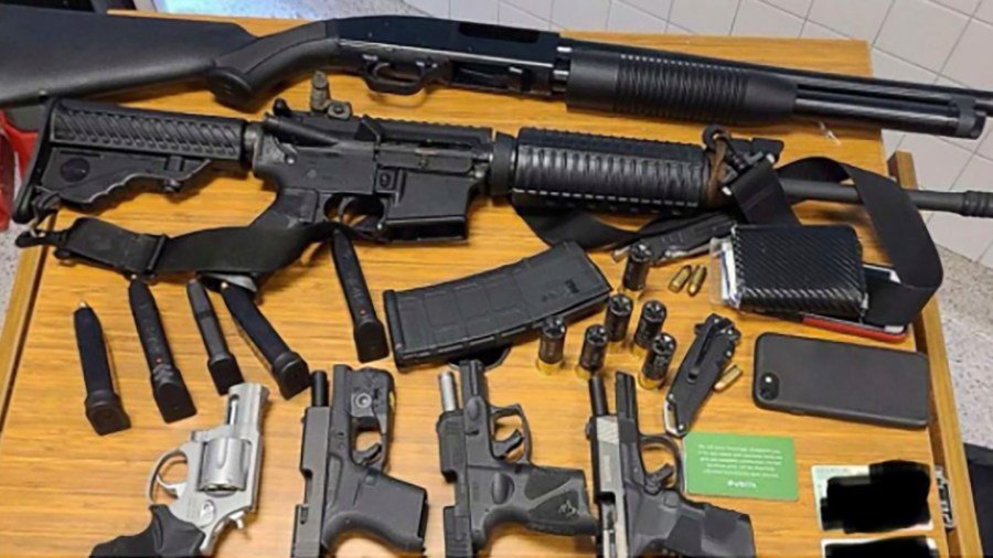 This photo provided by the Atlanta Police Department shows weapons Rico Marley was armed with at the time of his arrest on Wednesday, March 24, 2021. Authorities say Marley, who walked into an Atlanta grocery store with multiple guns and body armor, was spotted by a witness who immediately became suspicious and alerted management. (Atlanta Police Department via AP)