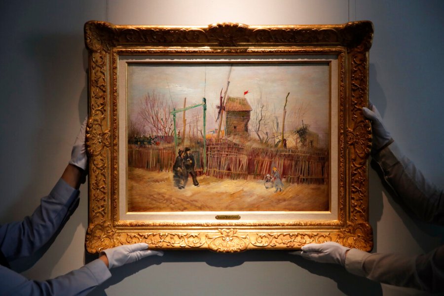 In this Feb. 25, 2021, file photo, Sotheby's personnel display (Street scene in Montmartre), a painting by Dutch master Vincent van Gogh at Sotheby's auction house in Paris. (AP Photo/Christophe Ena, File)