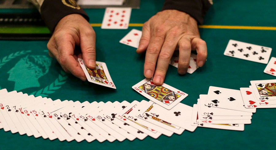 In this Feb. 27, 2013 file photo Jeff Martos resets a deck of cards during a break in poker play at Caesar's Palace, in Las Vegas. (AP Photo/Julie Jacobson, File)