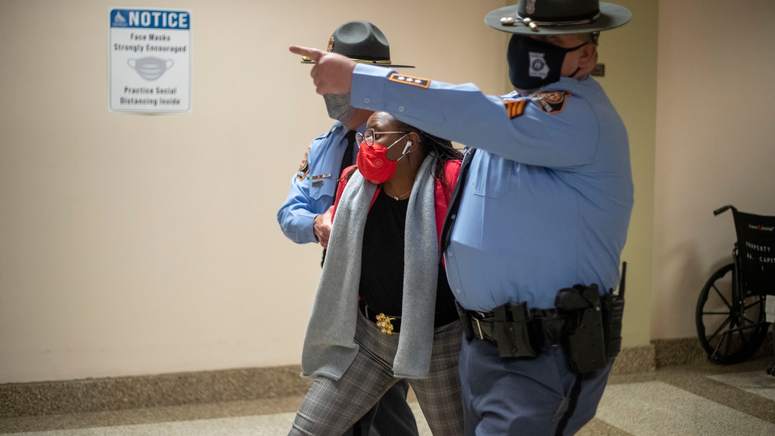 Rep. Park Cannon (D-Atlanta) is escorted out of the Georgia Capitol Building by Georgia State Troopers after being asked to stop knocking on a door that lead to Gov. Brian Kemp's office while Gov. Kemp was signing SB 202 behind closed doors at the Georgia State Capitol Building in Atlanta, Thursday, March 25, 2021. (Alyssa Pointer/Atlanta Journal-Constitution via AP)