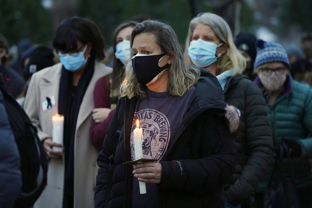 Mourners listen to speakers at a vigil for the 10 victims of the Monday massacre at a King Soopers grocery store late Thursday, March 25, 2021, at Fairview High School in Boulder, Colo. (AP Photo/David Zalubowski)