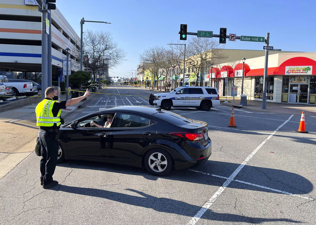 Virginia Beach police redirect traffic on March 27, 2021 after late night shootings as they investigate a late night shooting in Virginia Beach, Va. A pair of overnight fatal shootings along the beachfront in Virginia Beach wounded several people in a scene described by authorities on Saturday as “very chaotic.” (Stephen Katz/The Virginian-Pilot via AP)