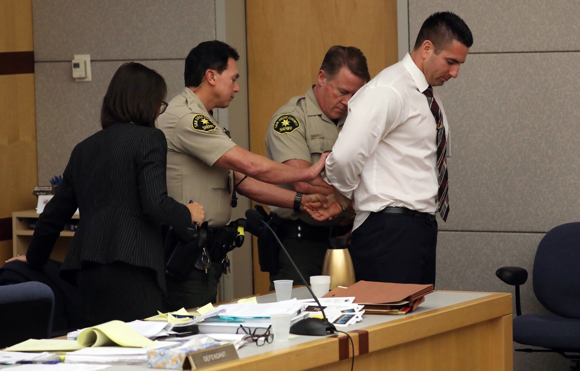 In this Tuesday, Dec. 10, 2019, file photo, former San Diego Sheriff's Deputy Richard Fischer is taken into custody after being sentenced to 44 months in jail in Vista, Calif. (John Gibbins/The San Diego Union-Tribune via AP, File)