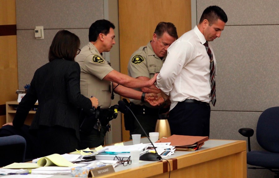 In this Tuesday, Dec. 10, 2019, file photo, former San Diego Sheriff's Deputy Richard Fischer is taken into custody after being sentenced to 44 months in jail in Vista, Calif. (John Gibbins/The San Diego Union-Tribune via AP, File)