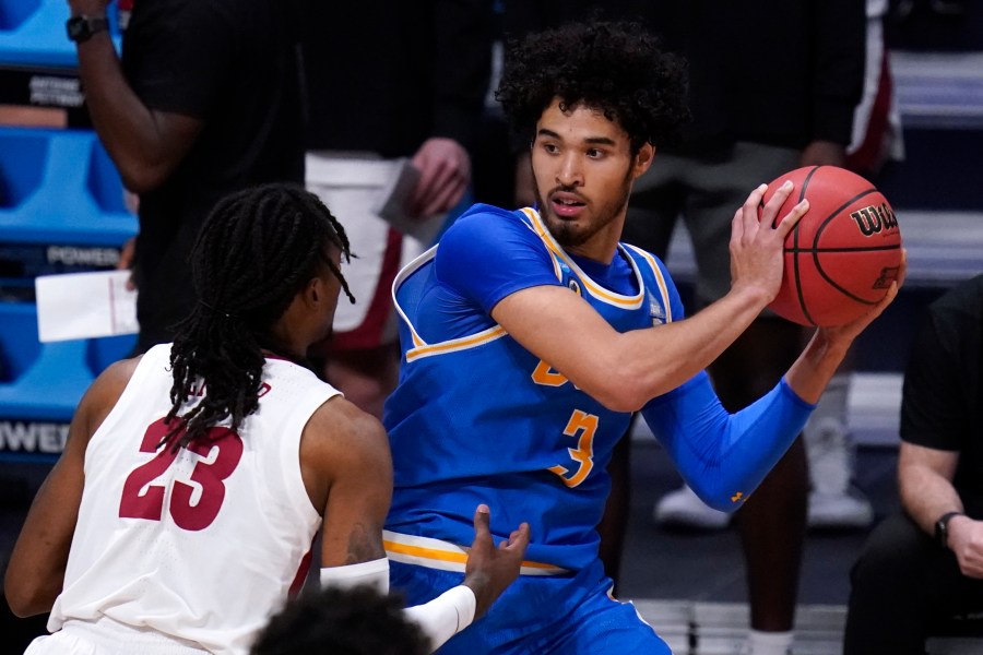 UCLA guard Johnny Juzang (3) protects the ball from Alabama guard John Petty Jr. (AP Photo/Michael Conroy)