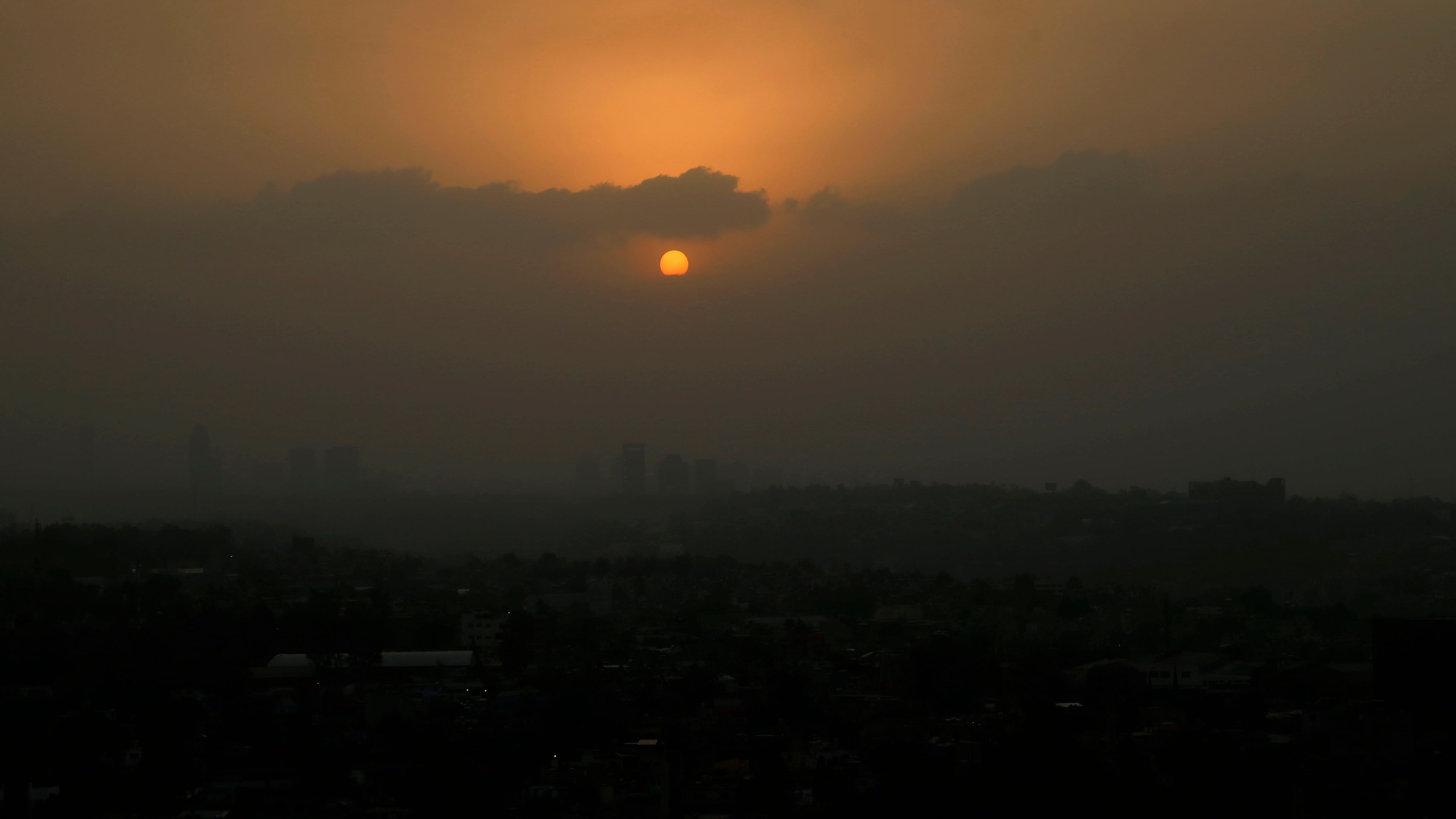 The sun sets amid a dust storm in Mexico City, Sunday, March. 28, 2021. (AP Photo/Marco Ugarte)