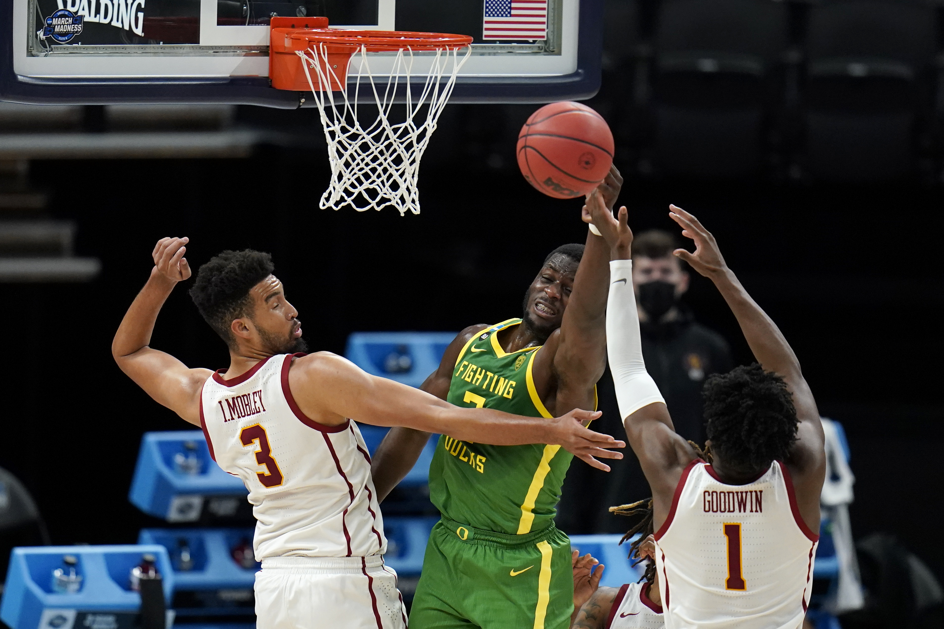 Oregon forward Eugene Omoruyi, center, fights for a rebound with Southern California forward Isaiah Mobley (3) and forward Chevez Goodwin (1) during the first half of a Sweet 16 game in the NCAA men's college basketball tournament at Bankers Life Fieldhouse, Sunday, March 28, 2021, in Indianapolis. (AP Photo/Jeff Roberson)