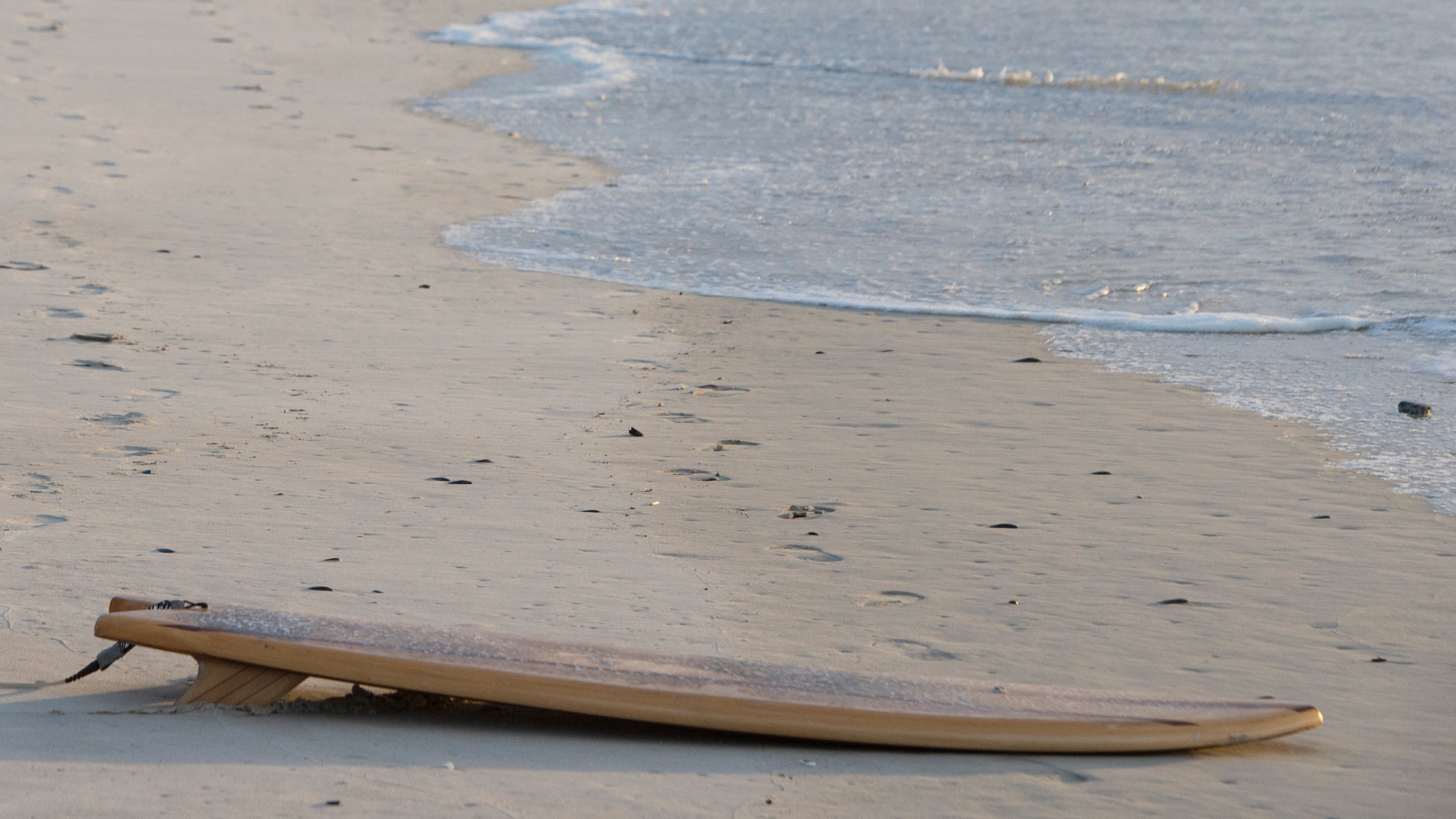 This file photo shows a surf board on a beach. (RODGER BOSCH/AFP via Getty Images)