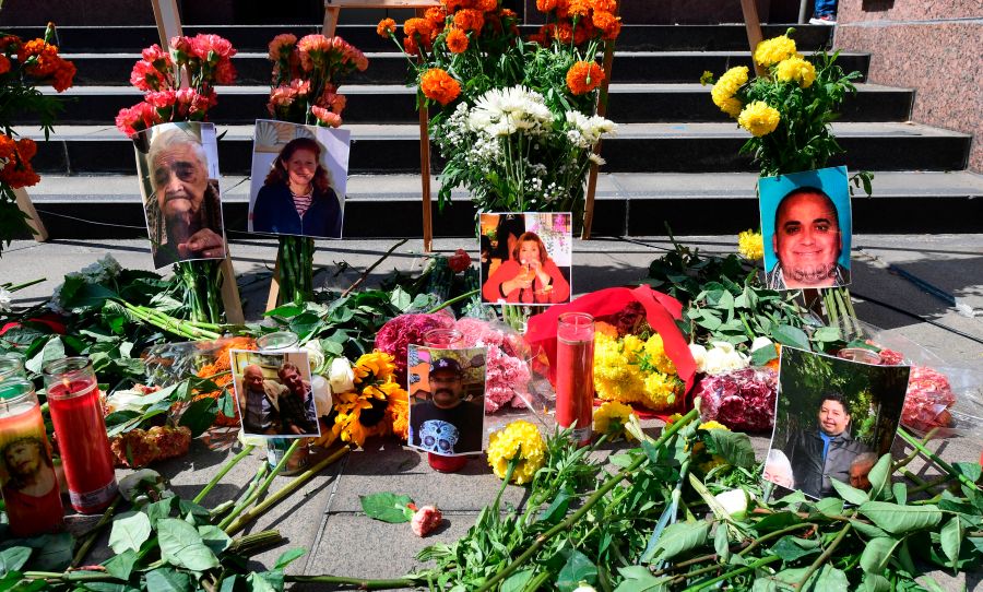 Flowers, candles and photographs are placed at a memorial honouring more than 5,700 residents of Los Angeles who lost their lives to coronavirus on August 31, 2020 in Los Angeles, California. (Frederic J. Brown/AFP via Getty Images)