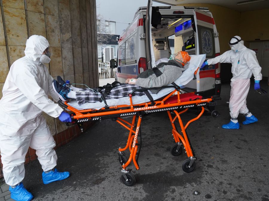 Two men in protective suits transport a coronavirus COVID-19 infected patient with an ambulance to a hospital in Warsaw, Poland, on Nov. 7, 2020, on the first day of the new partial lockdown. Poland enters another round of anti-virus restrictions, including the closure of cinemas, cultural institutions and most shops in shopping centres, as well as a total switch to remote learning, as the EU country of 38 million people saw a new 24-hour record of 24,692 new coronavirus cases on Nov. 4, 2020. (JANEK SKARZYNSKI / AFP via Getty Images)