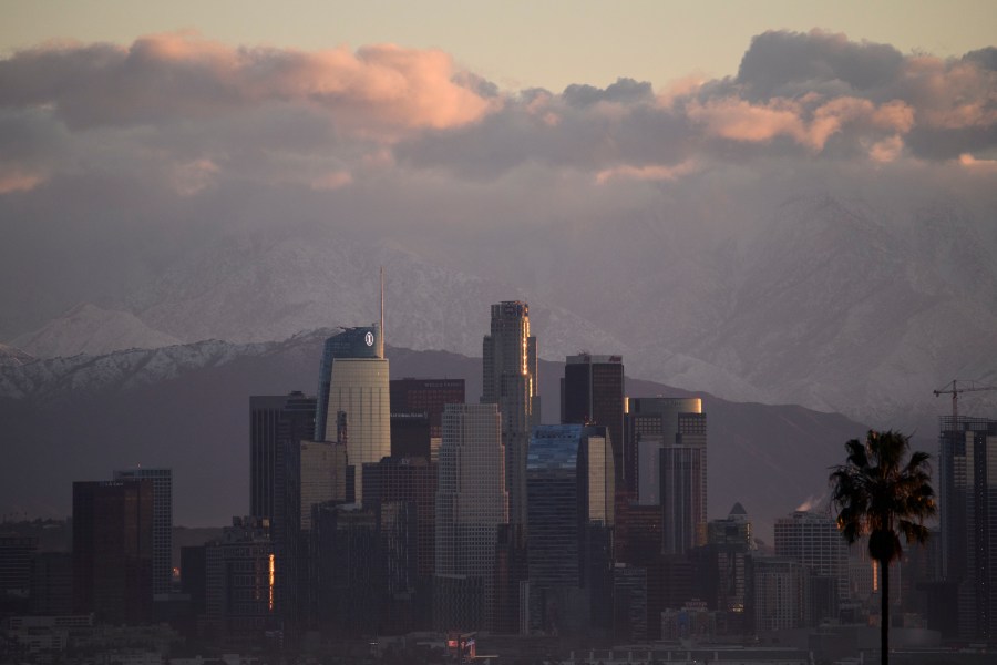 Snow-topped mountains stand behind the Los Angeles downtown skyline and Hollywood sign after sunrise following heavy rains as seen from the Kenneth Hahn State Recreation Area on December 29, 2020 in Los Angeles, California. (Patrick T. Fallon/AFP via Getty Images)