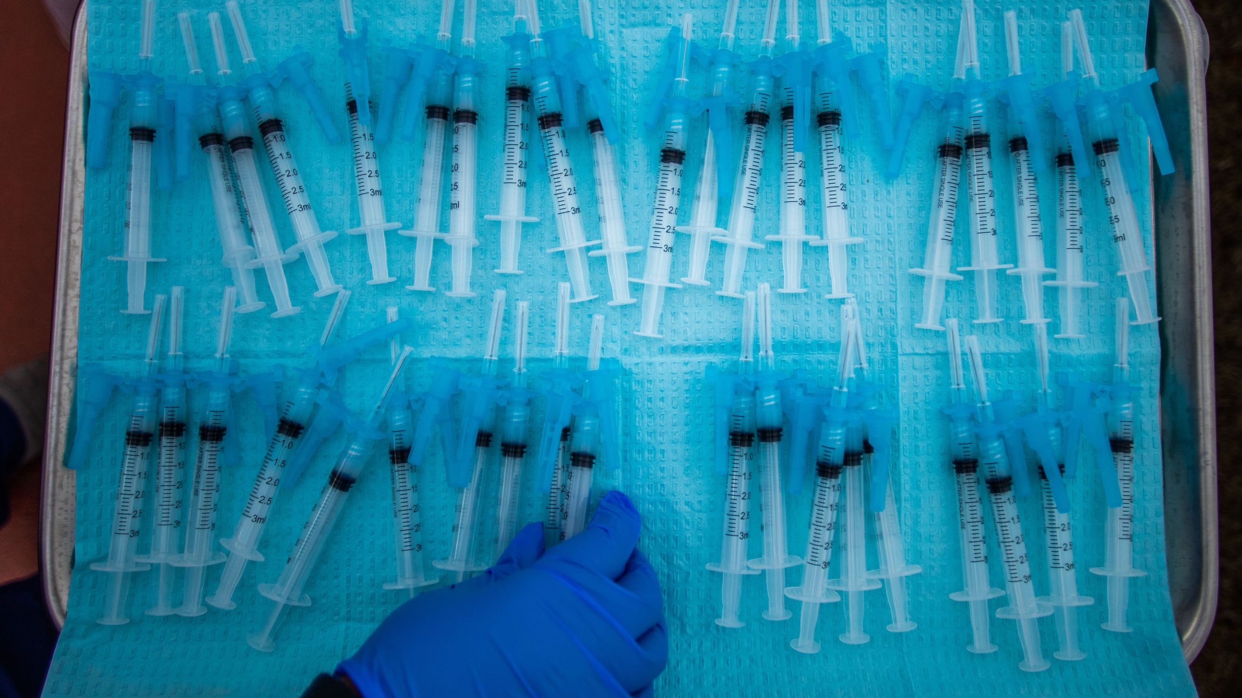 A nurse takes a Moderna Covid-19 vaccines ready to be administered at a vaccination site at Kedren Community Health Center, in South Central Los Angeles, California on February 16, 2021. (Photo by Apu GOMES / AFP)