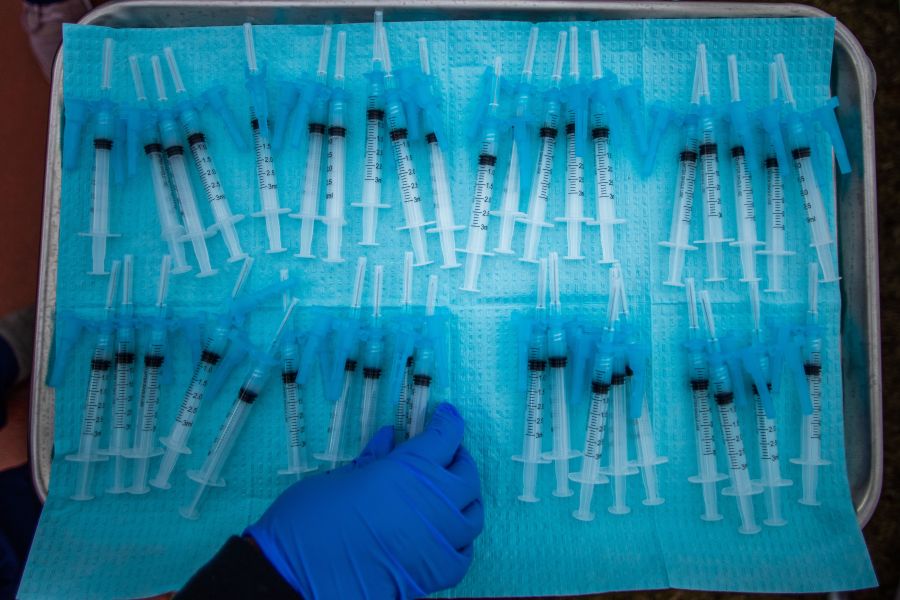 A nurse takes a Moderna Covid-19 vaccines ready to be administered at a vaccination site at Kedren Community Health Center, in South Central Los Angeles, California on February 16, 2021. (Photo by Apu GOMES / AFP)