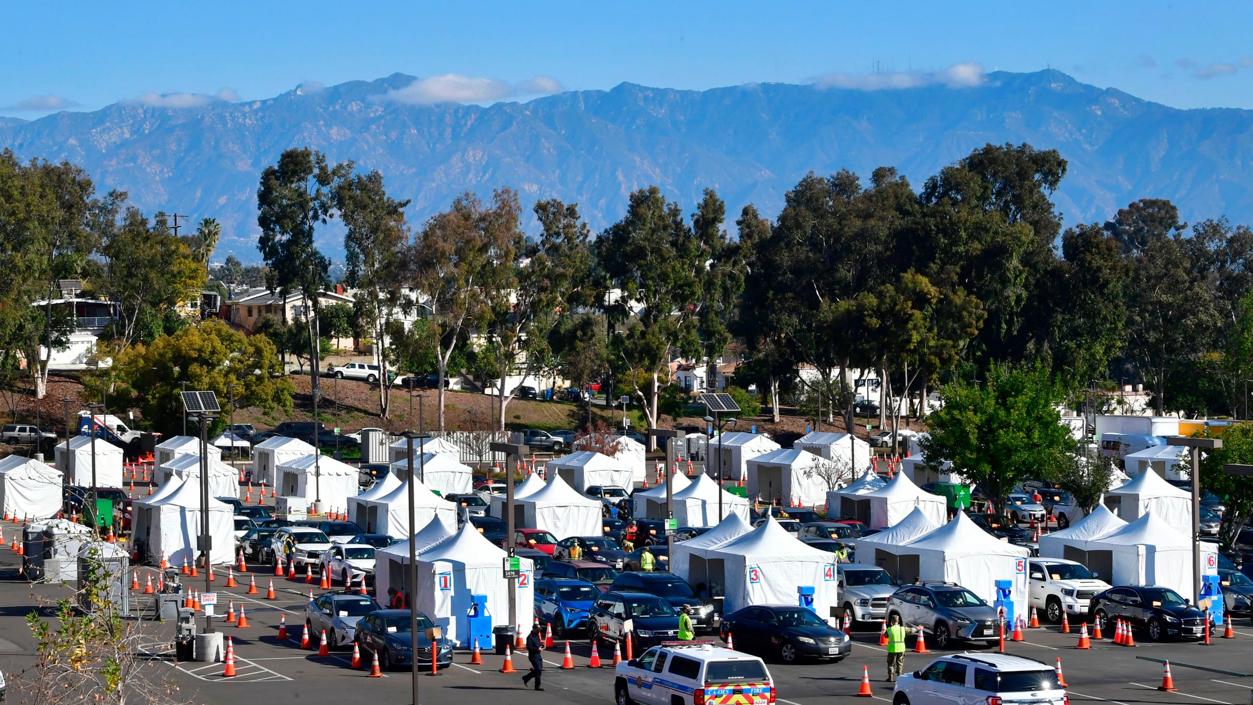 People in vehicles arrive for their COVID-19 vaccine on campus at Cal State Los Angeles on March 4, 2021.(Frederic J. Brown / AFP / Getty Images)