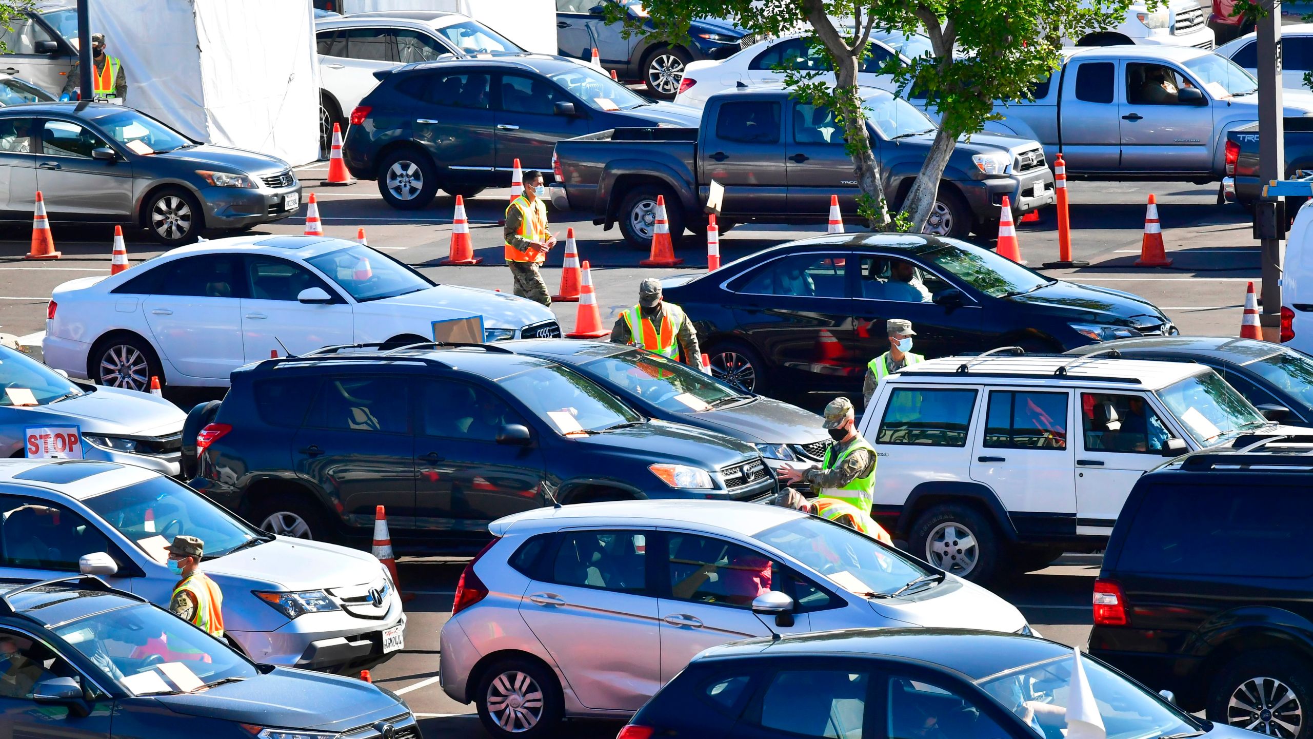 People in vehicles arrive for their COVID-19 vaccine on campus at California State University of Los Angeles on March 4, 2021. (FREDERIC J. BROWN/AFP via Getty Images)