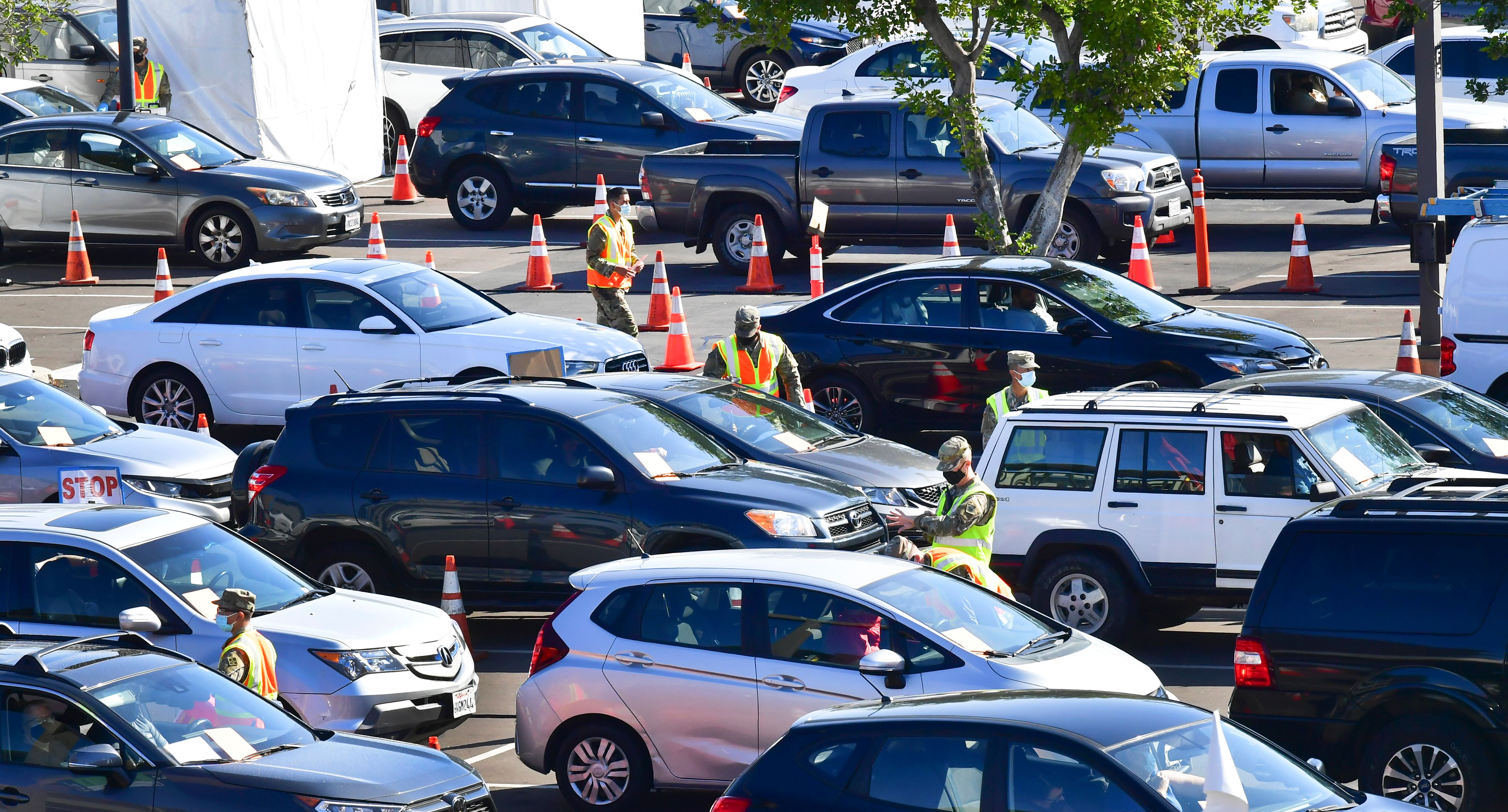 People in vehicles arrive for their COVID-19 vaccine on campus at California State University of Los Angeles on March 4, 2021. (FREDERIC J. BROWN/AFP via Getty Images)