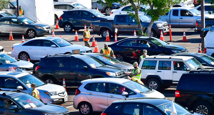 People in vehicles arrive for their COVID-19 vaccine on campus at California State University of Los Angeles on March 4, 2021. (FREDERIC J. BROWN/AFP via Getty Images)