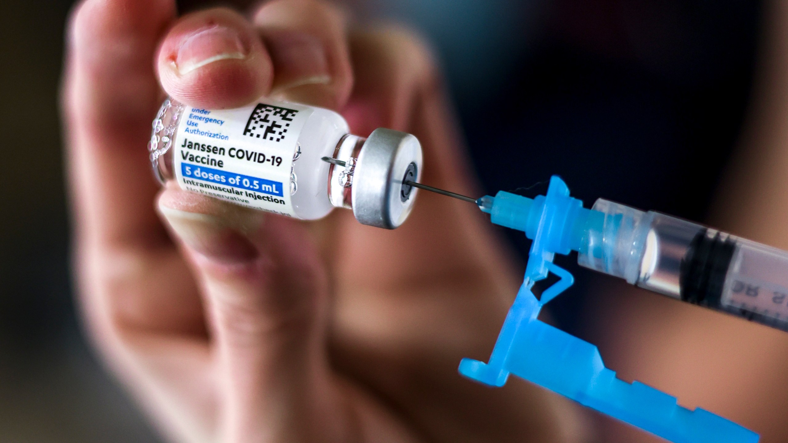 Adams 12 Five Star Schools District RN Tiffany Karschamroon draws a dose from a vial of the Johnson & Johnson COVID-19 vaccine. (Michael Ciaglo/Getty Images)