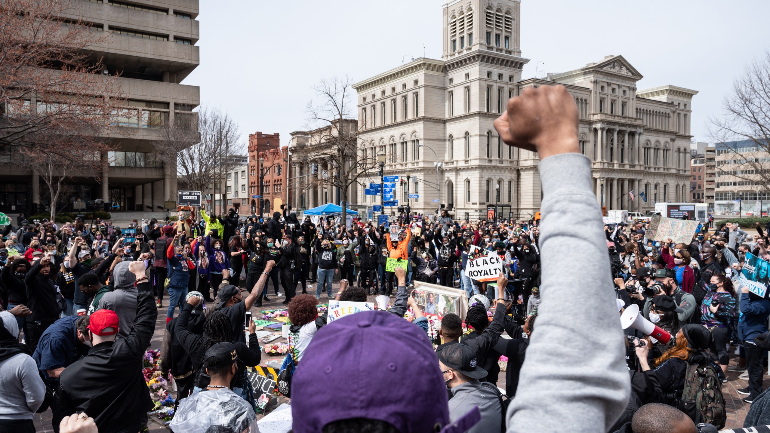 A protest organizer raises his fist toward the crowd during a Breonna Taylor memorial protest in Jefferson Square Park on March 13, 2021 in Louisville, Kentucky. (Jon Cherry/Getty Images)