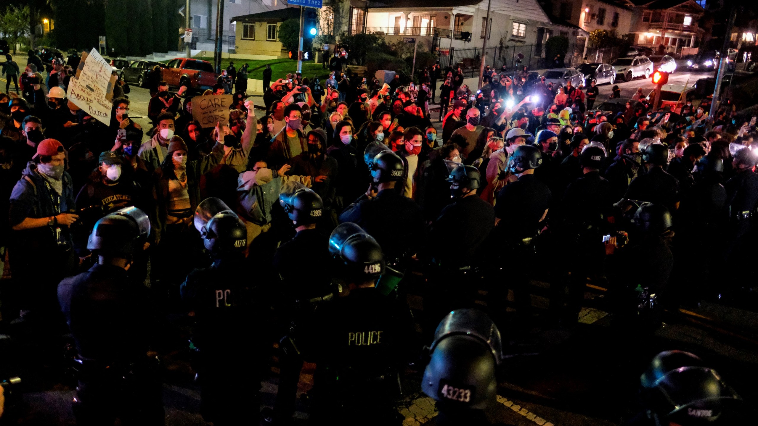 Activists and supporters of residents of a homeless encampment confront police at Echo Park Lake on March 24, 2021, ahead of a planned and announced clearing of the encampment (RINGO CHIU / AFP / Getty Images)