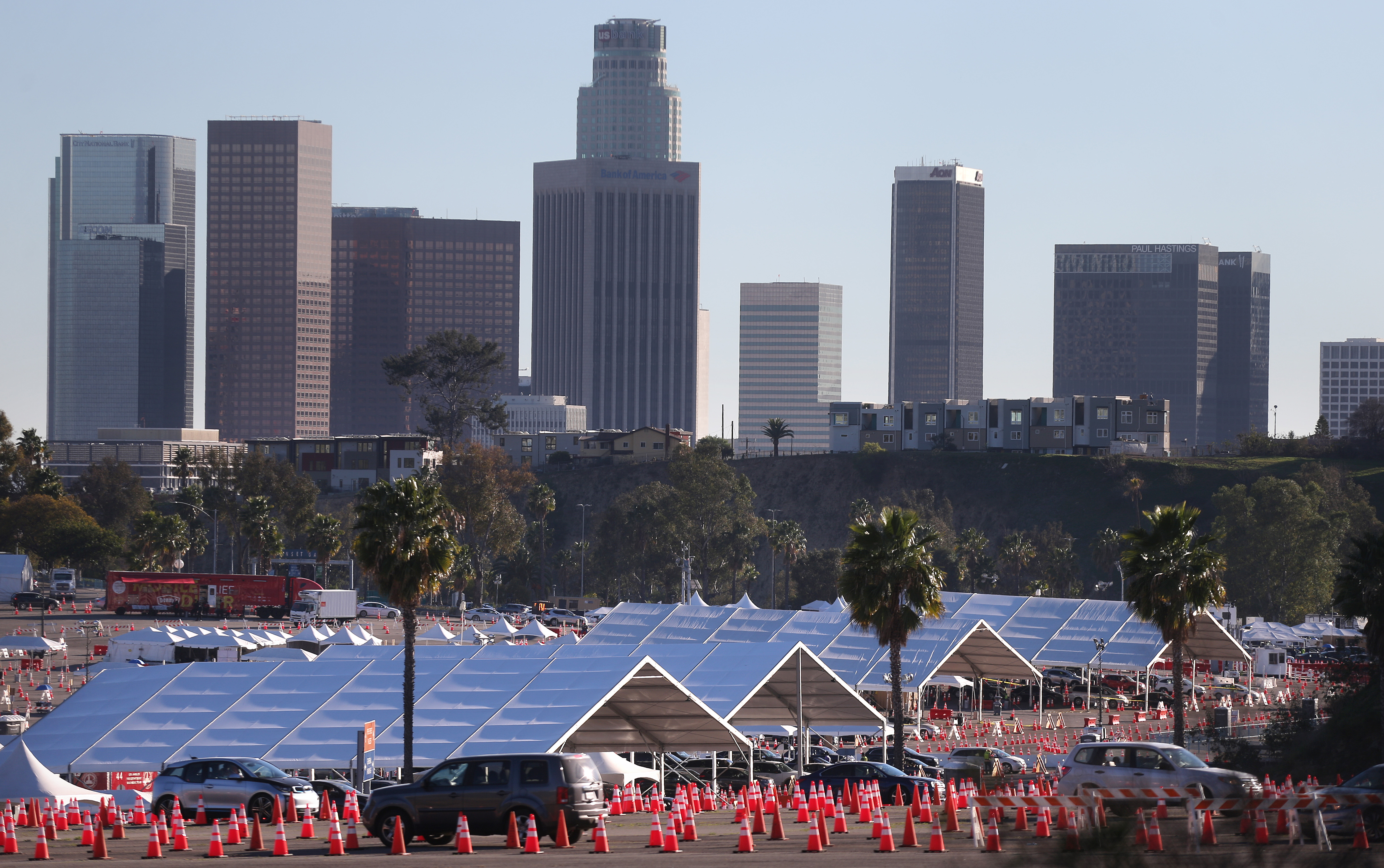 Cars are lined up at the mass COVID-19 vaccination site at Dodger Stadium on February 23, 2021 in Los Angeles, California. (Photo by Mario Tama/Getty Images)