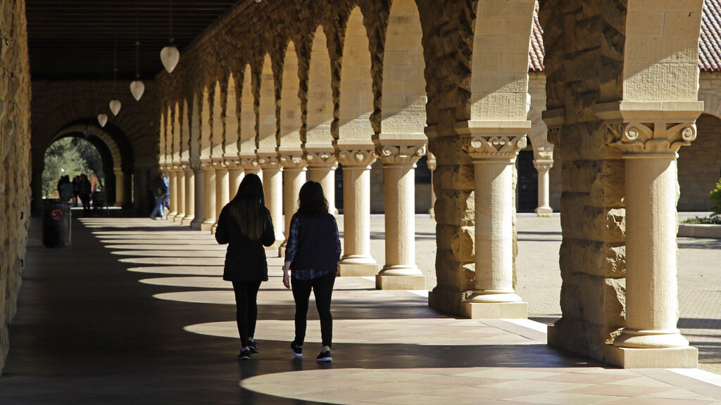 In this March 14, 2019, file photo students walk on the Stanford University campus in Santa Clara, Calif. (AP Photo/Ben Margot, File)