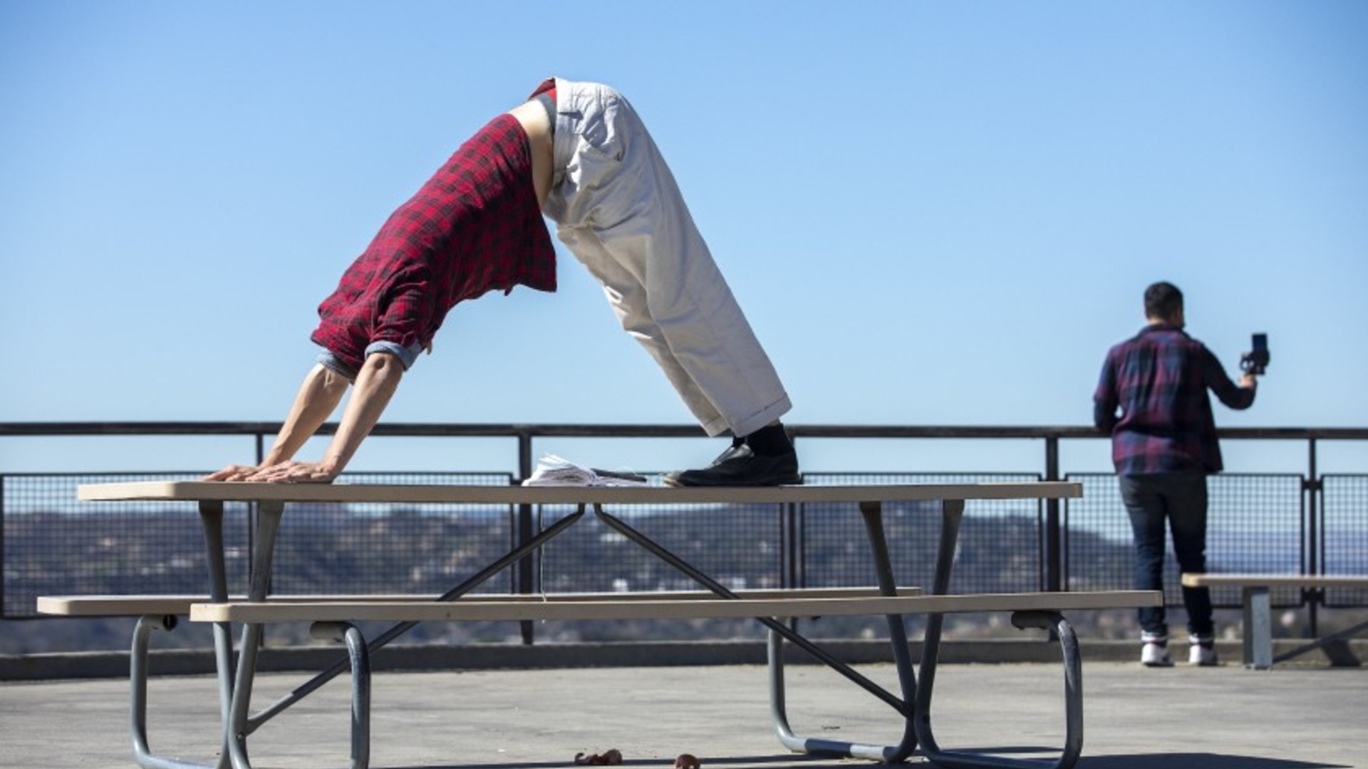 Cortez Beato of Los Angeles strikes a yoga pose outside the Griffith Park Observatory, part of his routine consisting of 12 poses known as Sun Salutations. The Los Angeles Basin could see rain Wednesday.(Mel Melcon / Los Angeles Times)