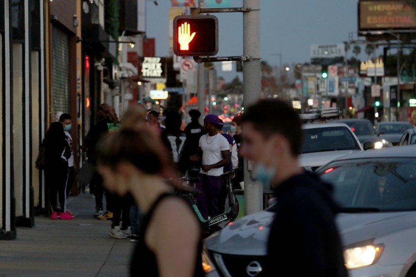 Shoppers walk along Melrose Avenue on March 1, 2021.(Luis Sinco / Los Angeles Times)