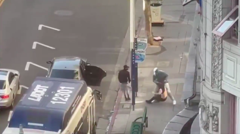 Surveillance video shows a February robbery and shooting in progress in downtown Los Angeles.(Los Angeles Police Department)