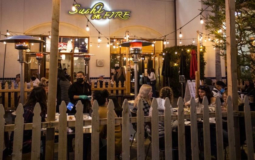 People dine outdoors at a restaurant in Huntington Beach on Jan. 26, 2021. (Allen J. Schaben/ Los Angeles Times)