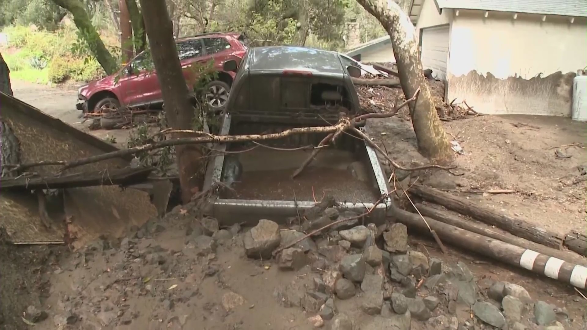 A truck is seen buried in debris following a mudslide in Silverado Canyon on March 10, 2021. (KTLA)