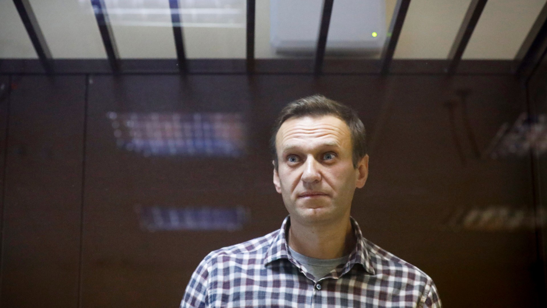 In this Feb. 20, 2021, file photo, Russian opposition leader Alexei Navalny stands in a cage in the Babuskinsky District Court in Moscow, Russia. (AP Photo/Alexander Zemlianichenko, File)